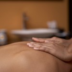 hands massaging back of a woman