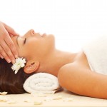 Young attractive girl receiving head massage at spa resort